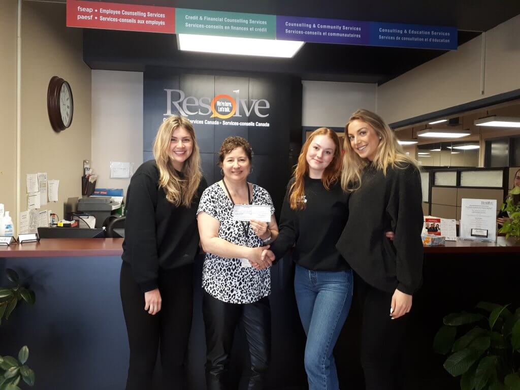 “Lauren Balogh, Mary-Claire Verbeke and April Christiansen of QLIFT present a cheque for $174.87 to Anne Gauthier of Resolve Counselling Services Canada”